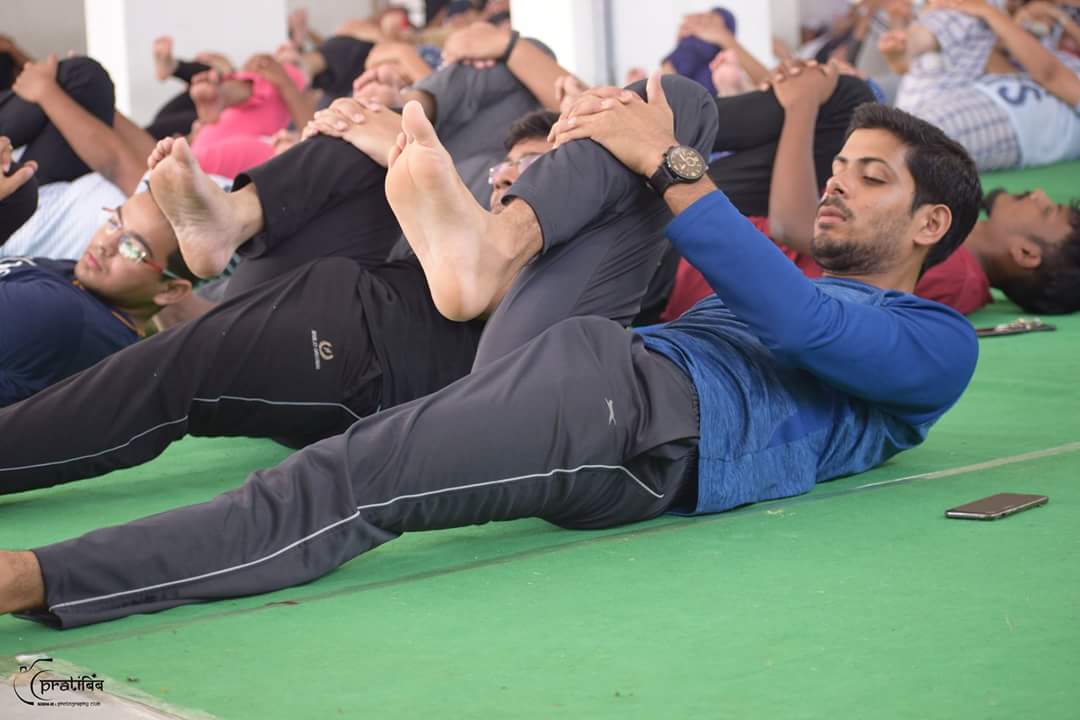 Students, Faculty, Staff preforming Yoga at SIBM